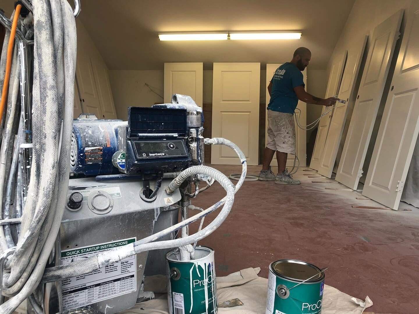 Airless spray rig set up to finish a batch of interior doors