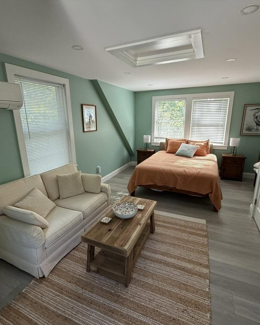 Finished bedroom painted in soft green with white trim