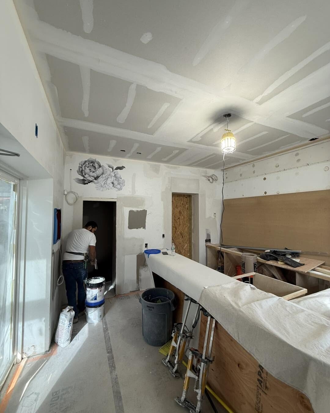 Ceiling seams taped while the crew finishes a kitchen