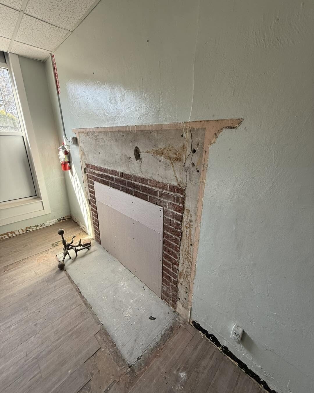 Fireplace wall opened for plaster and masonry repair