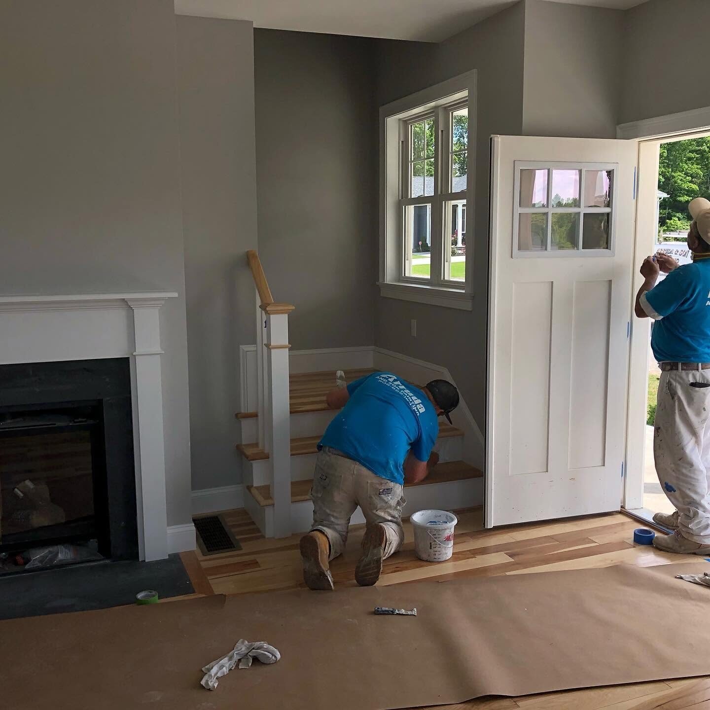Painters cutting in trim and doors during an interior repaint