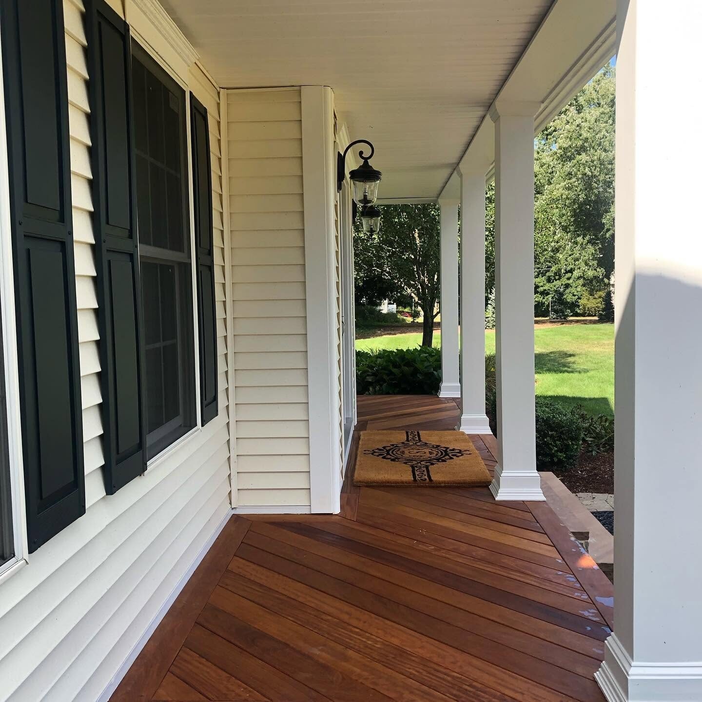 Stained mahogany porch decking on a covered farmers porch