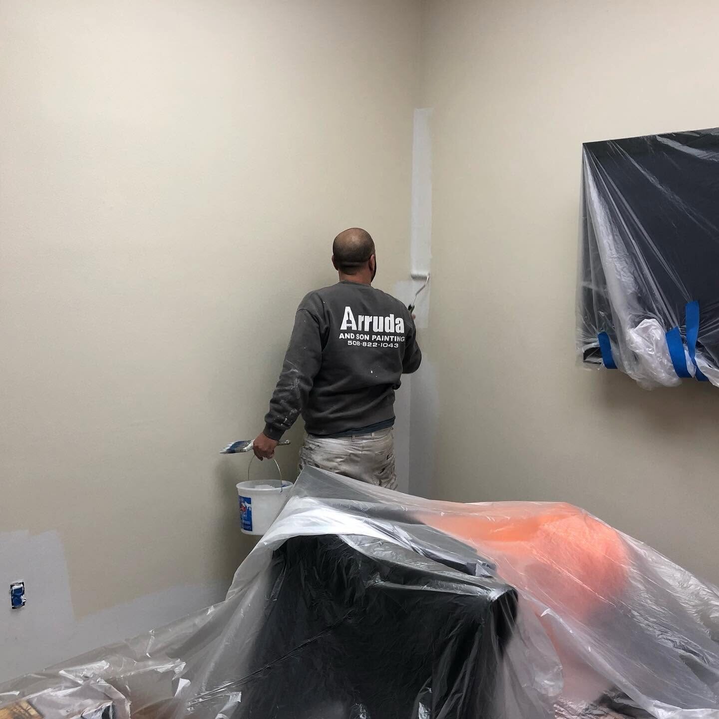 Val Arruda & Son painter cutting in an office wall