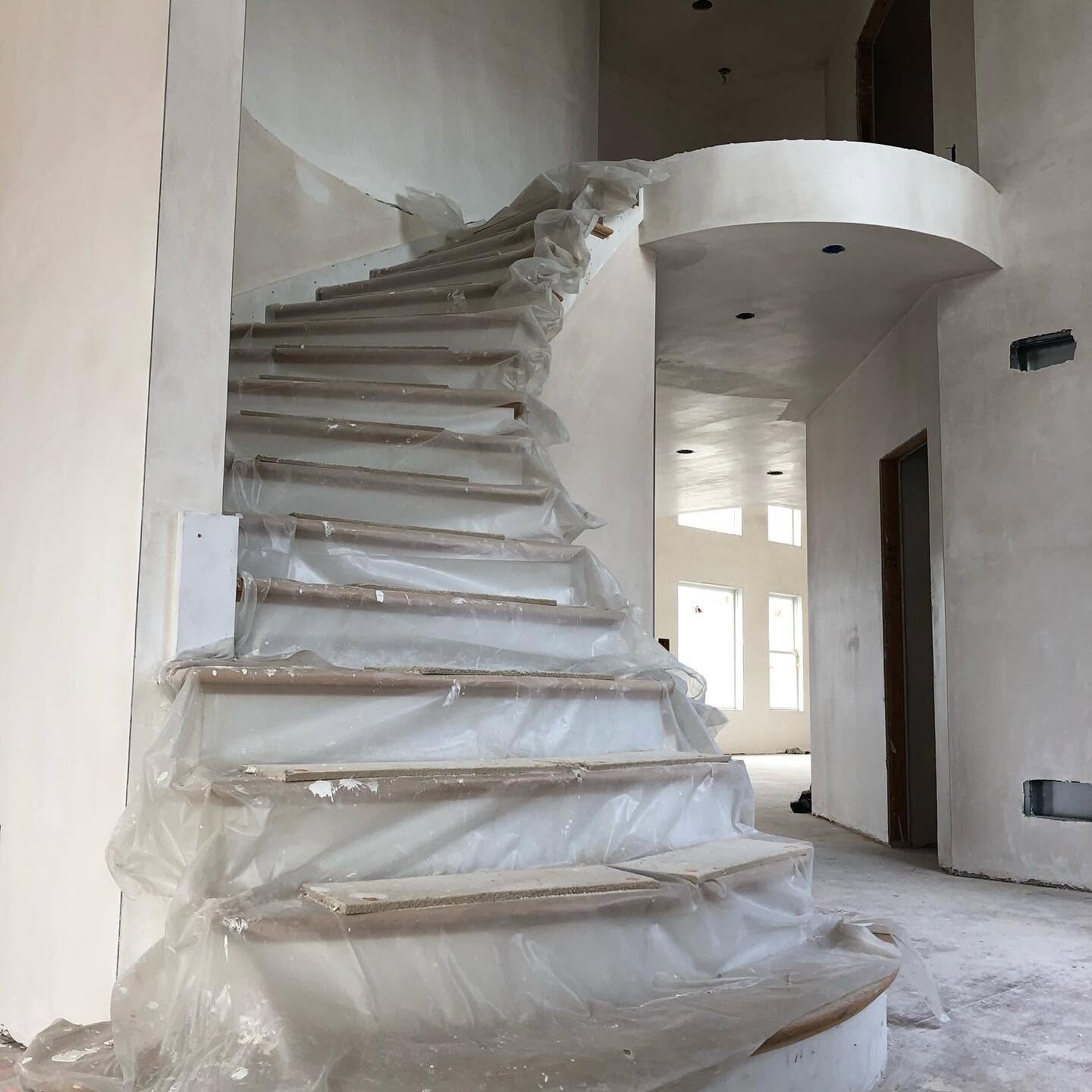 Curved staircase walls finished in plaster