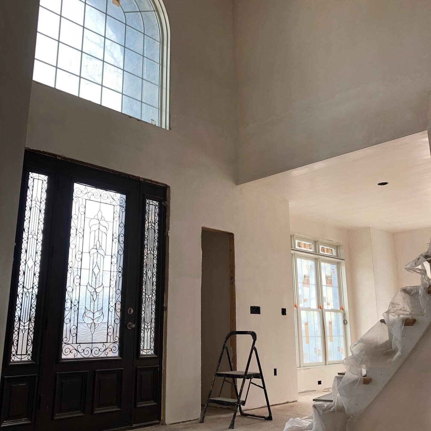 Two-story foyer with smooth plaster walls