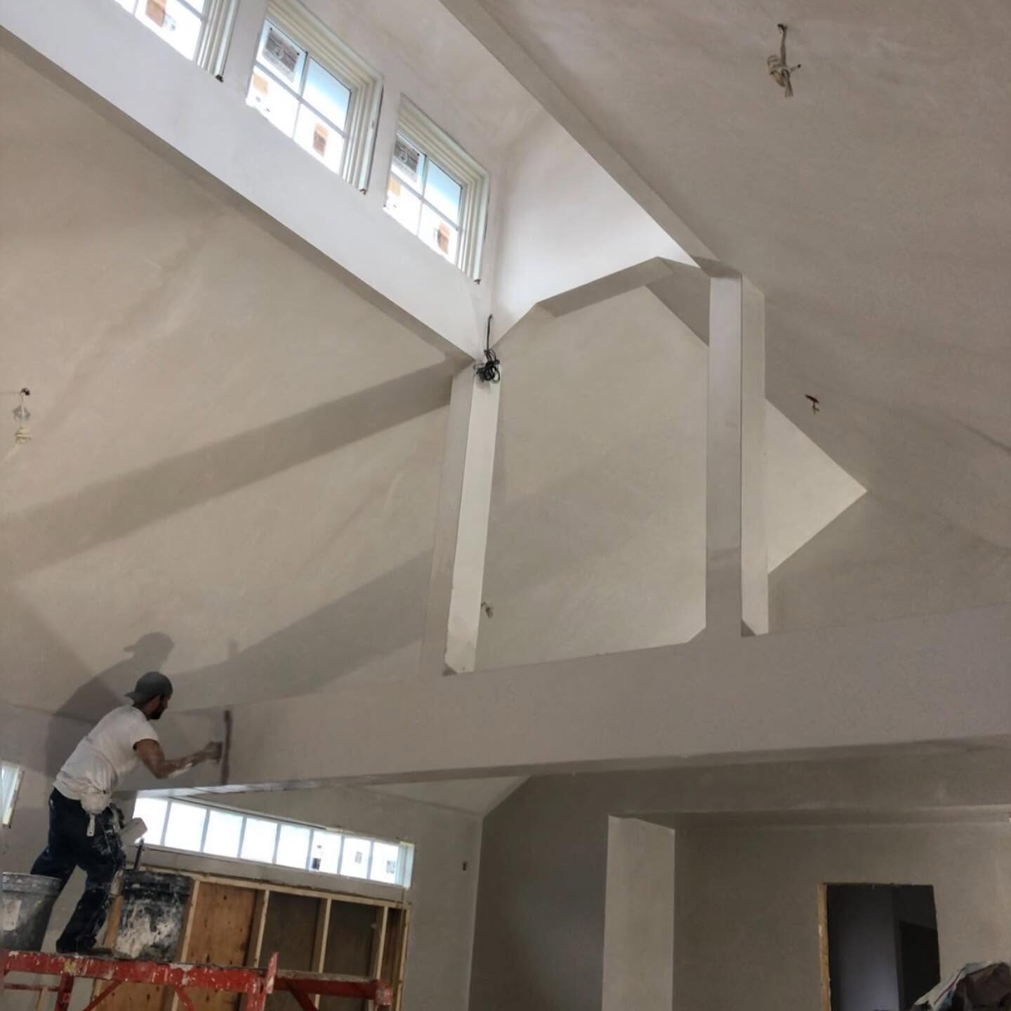 Plasterer finishing a vaulted room