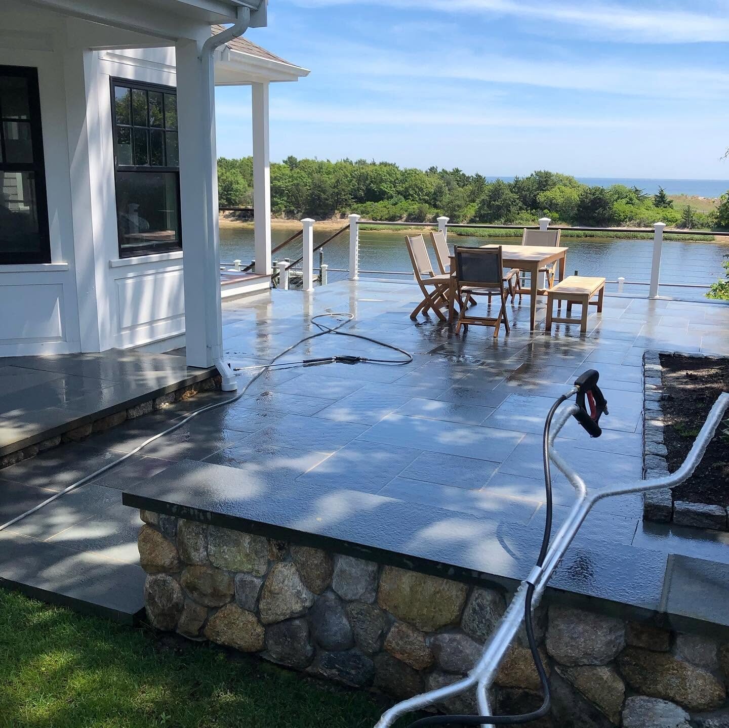 Power washing a waterfront stone patio