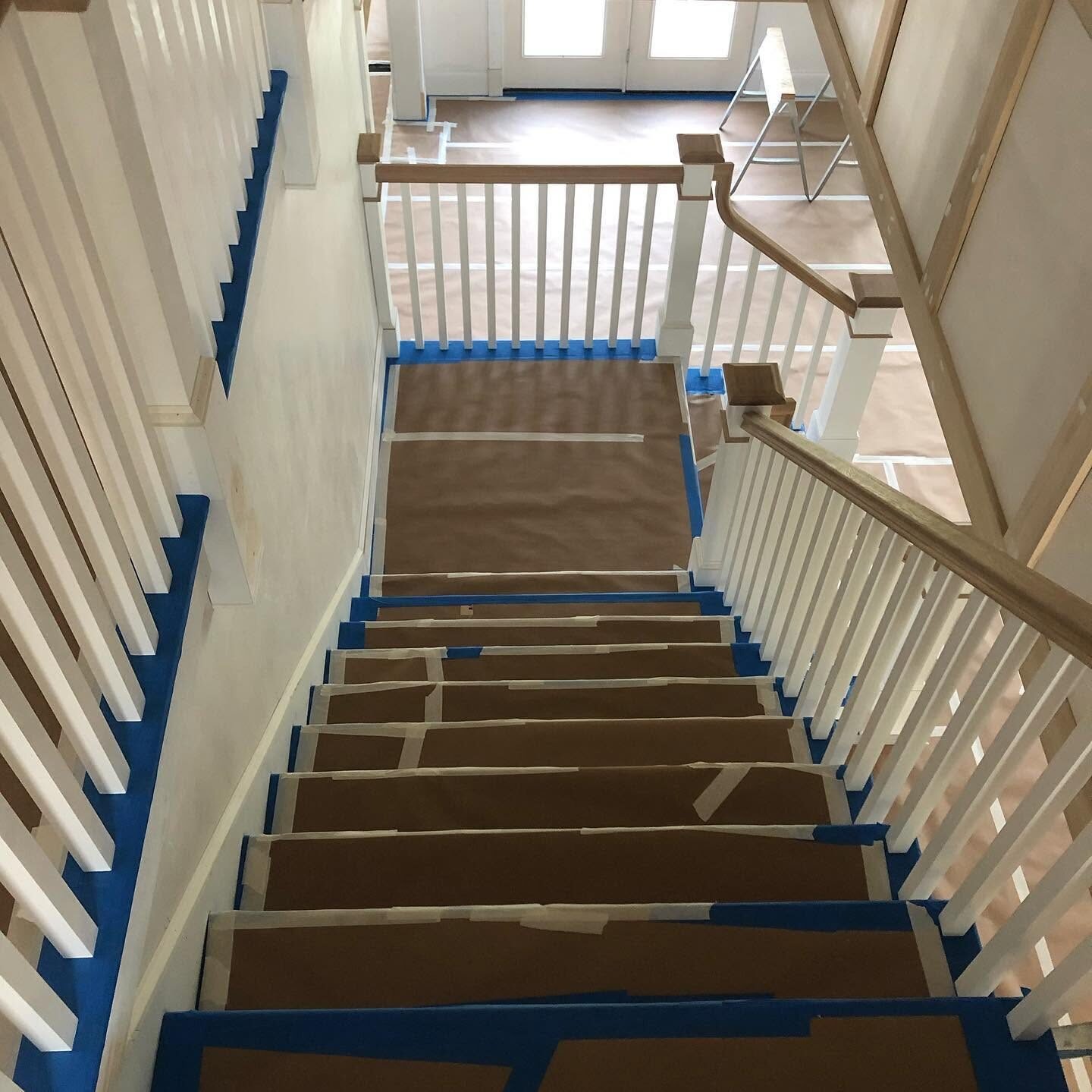 Staircase masked and papered before painting the balusters and trim