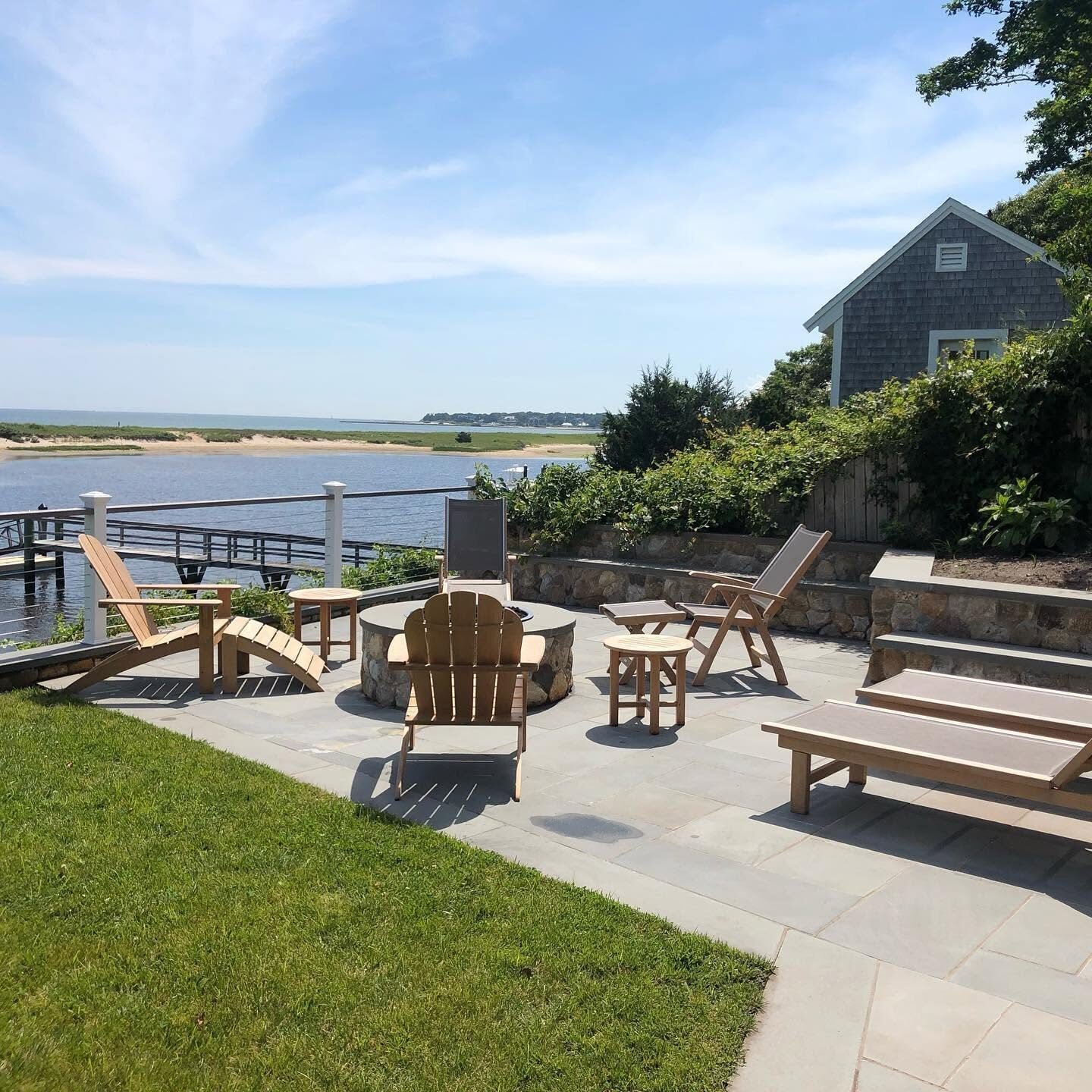 Waterfront patio and lawn at a coastal Rhode Island property