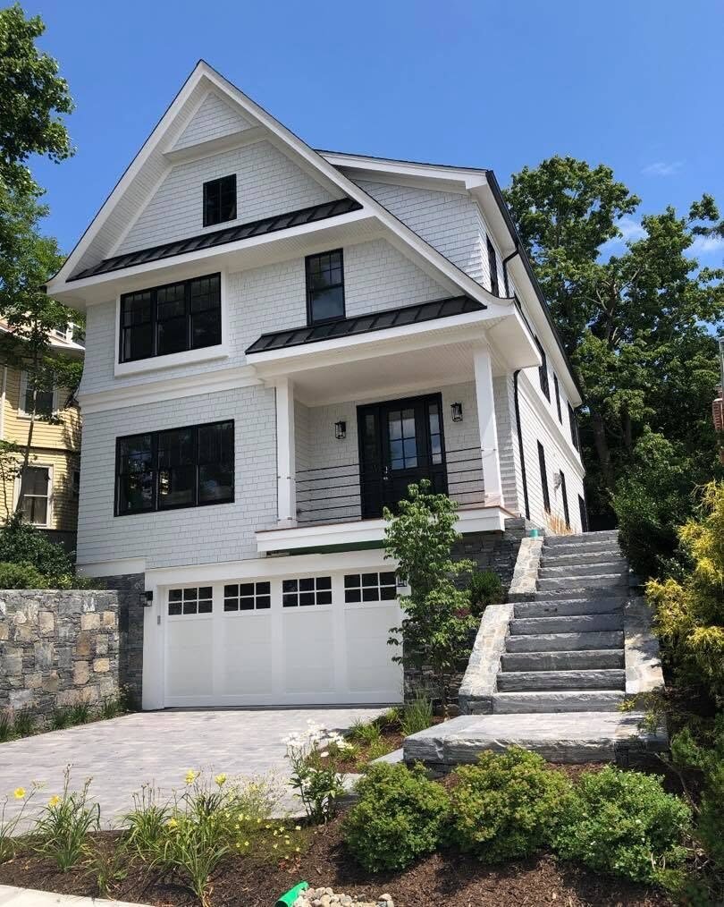 White shingle home with black windows after painting